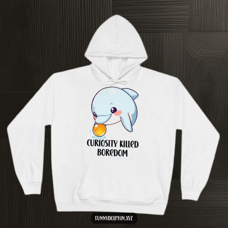 Funny hoodie depicting a curious dolphin with wide, excited eyes inspecting a shiny, foreign object. Full of wonder!
