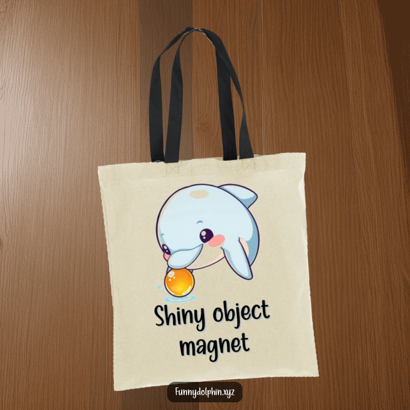 Funny tote bag showing a curious dolphin with wide, excited eyes inspecting a shiny object. Ideal for the inquisitive mind.